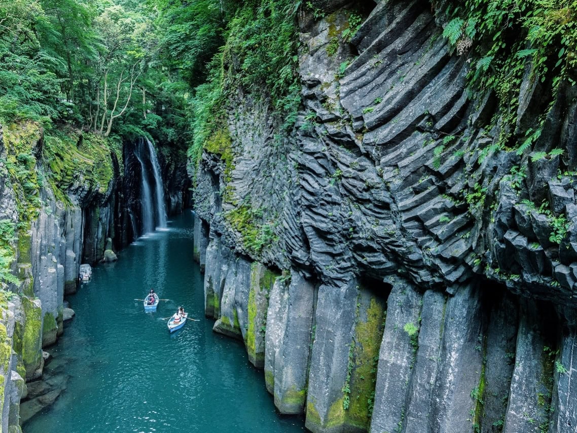 Takachiho Gorge in Miyazaki with waterfall, boats, and columnar cliffs